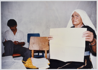 Shukreyyeh Abdel-Hadi Holds Up Papers Proving Her Ownership of Land in the Village of Nabi Samuil, the 1990s
