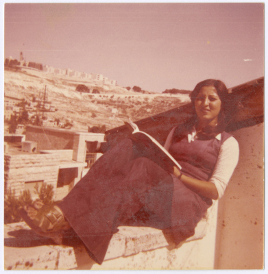 Amal al-Qasim Reading on a House Rooftop, Jerusalem, the 1970s 