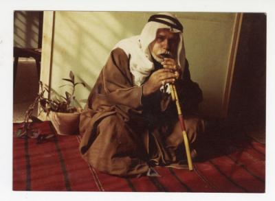 A Palestinian man playing the flute, Al Samu, 1980s
