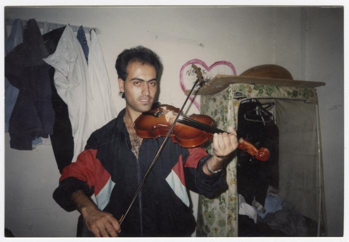 Yasir Barakat Playing the Violin, Jabalia Camp, 1990s