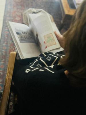 Widad Kawar is checking Threads of Identity Book, Amman, 2024