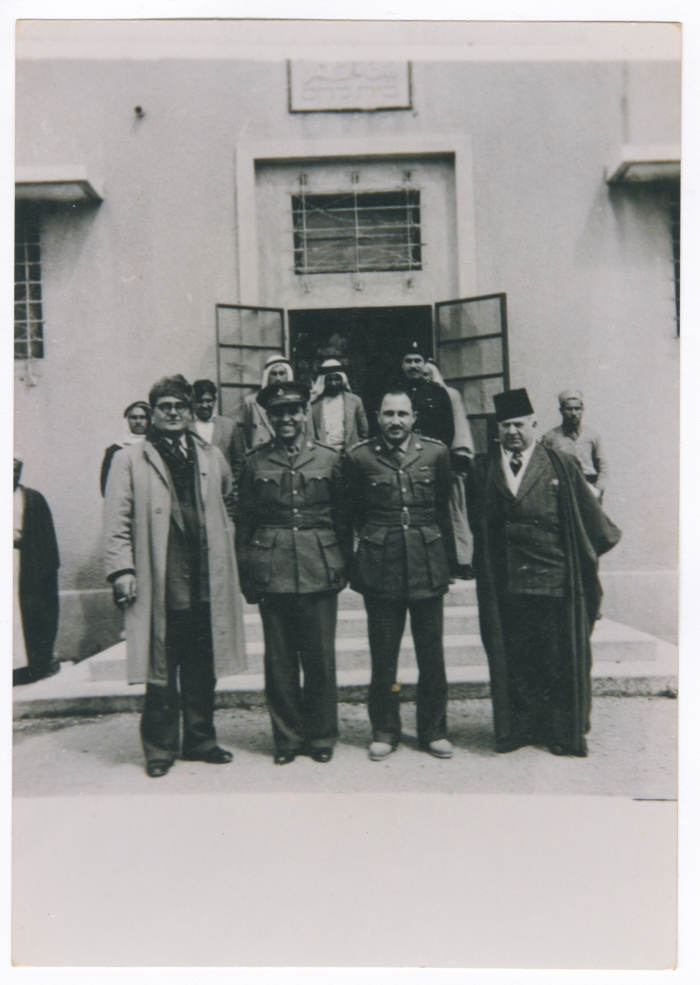 Jeries Abu Rummaneh and a group of men wearing military uniforms before Bethlehem's Municipality