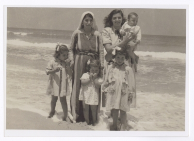 A Photograph of Ellen Abu Rumman with Her Children and Housekeeper on the Gaza Beach, 1953
