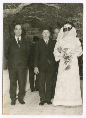 Maha El-Saca standing before her house, on her wedding day