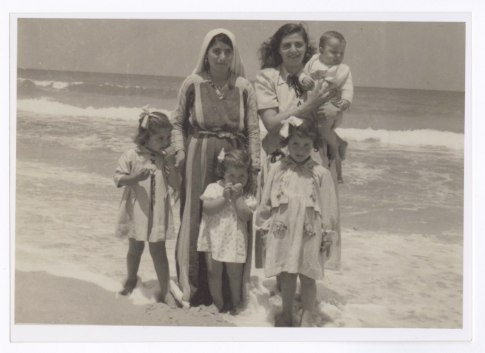 A Photograph of Ellen Abu Rumman with Her Children and Housekeeper on the Gaza Beach, 1953