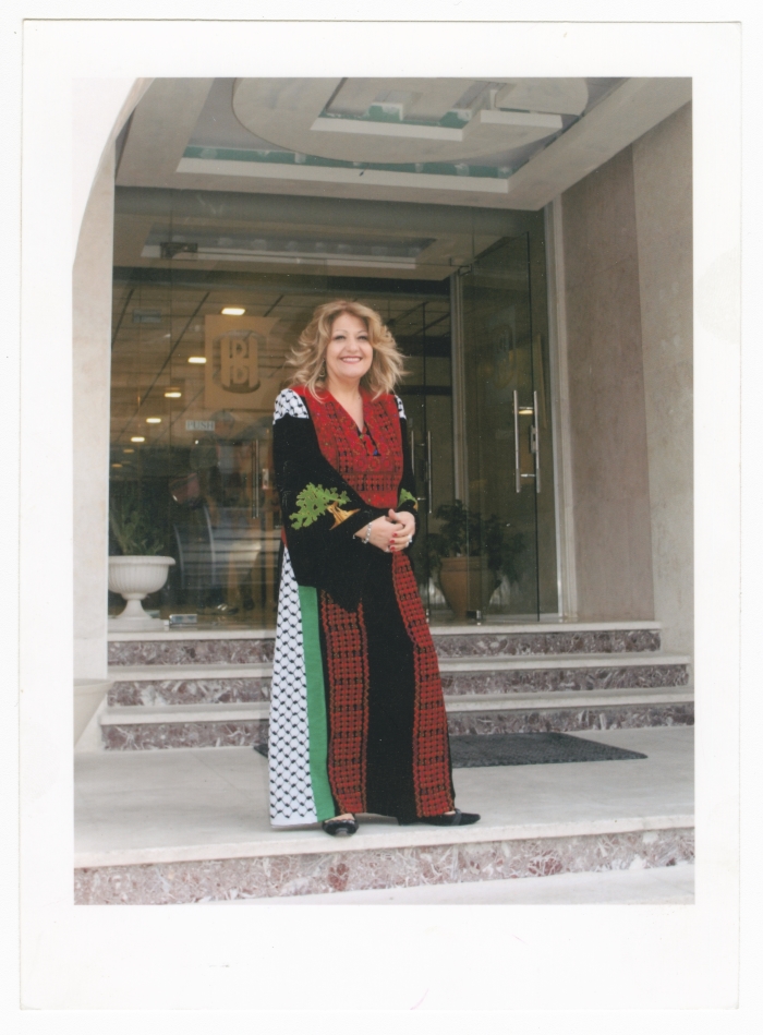 Maha El-Saca wearing a miniature replica of her Palestinian traditional dress that holds a place in Guinness World Records