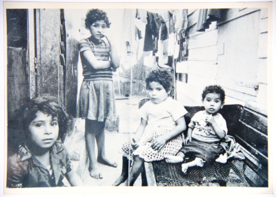 A Photograph of a Group of Children Outside Their Home in Hebron City