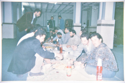 A Photograph of a Group of Men Having a Wedding Ceremony Lunch in Sa