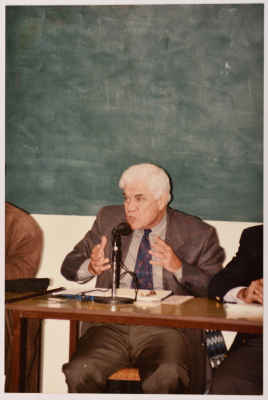 A Man Speaking at a Meeting
