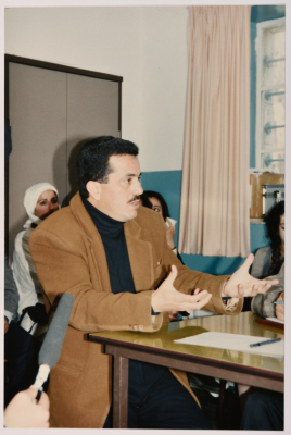 A Man Speaking at a Meeting
