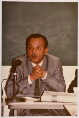 A Man Speaking at a Meeting
