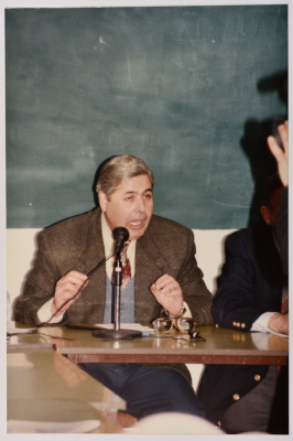 A Man Speaking at a Meeting
