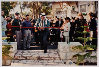 An Old Man Cutting The Opening Ribbon