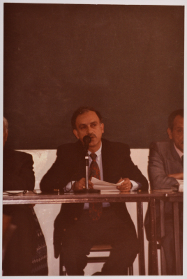A Man Speaking at a Meeting
