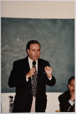 A Man Speaking at a Meeting