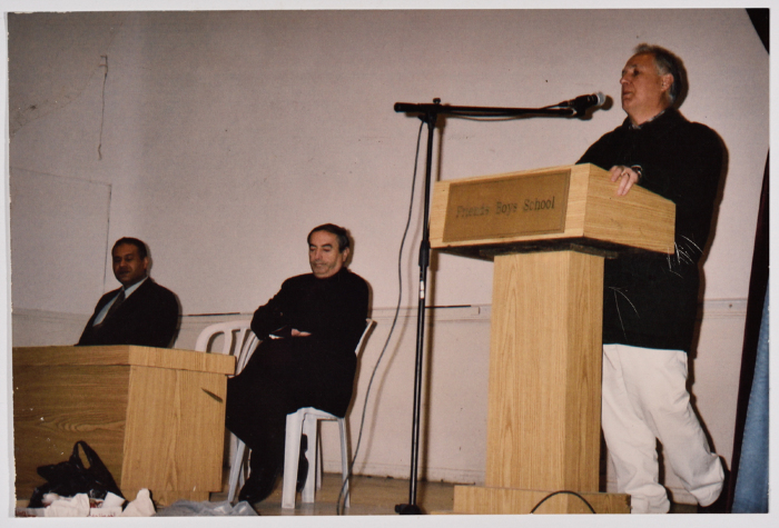Three Men Standing on a Stage 