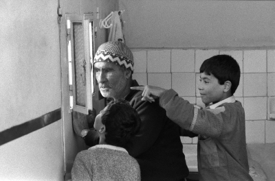 Mohammad Abu Libdeh and His Father Looking through their Window, al-Am