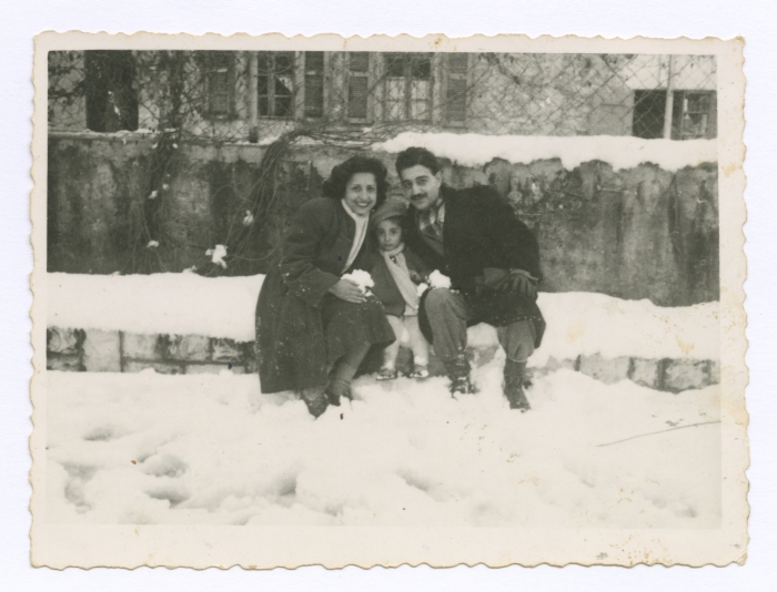 Emile Habibi in the snow with his wife and daughter