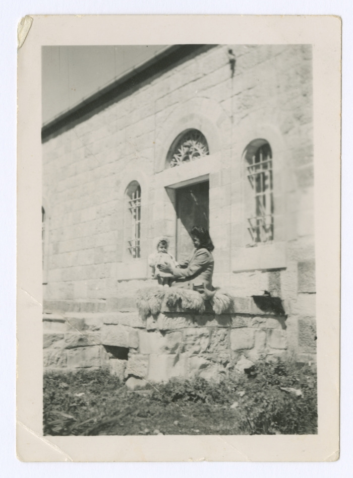 Emile Habibi's wife with her daughter in the backyard of their house