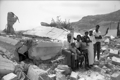 A Photograph of a Family in Front of Their Demolished House in Jericho, 1989