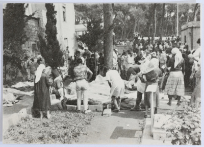 People Examining Corpses in a Cemetery 