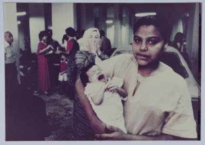 A Girl Holding a Crying Child 