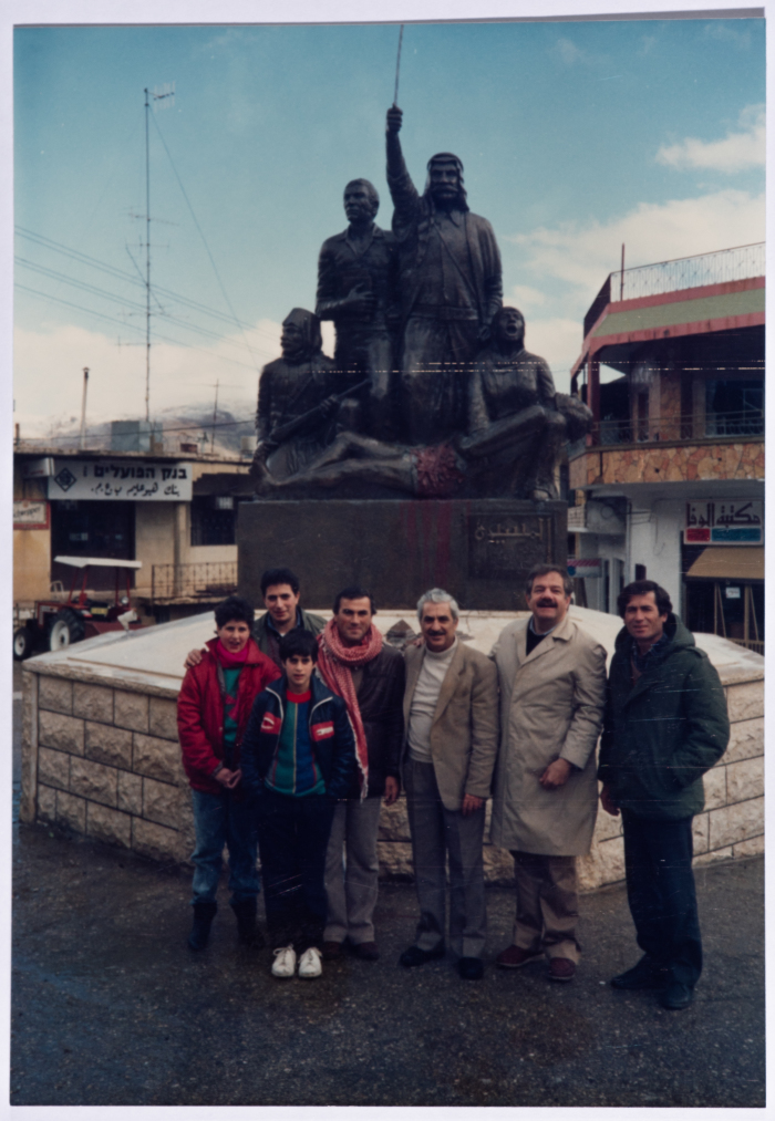 Tawfiq Ziad in front of the statue of the march in the town of Majdal Shams