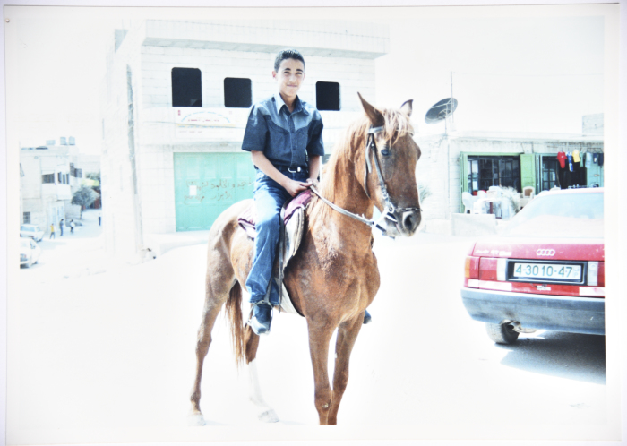 A Photograph of a Young Palestinian Man from al Jaradat Family Riding a Horse in Raʾs al-ʿĀrud