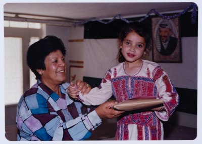 Handing certificates at the graduation ceremony of the kindergarten of Qalandiya Camp Women Handicraft Cooperative Society