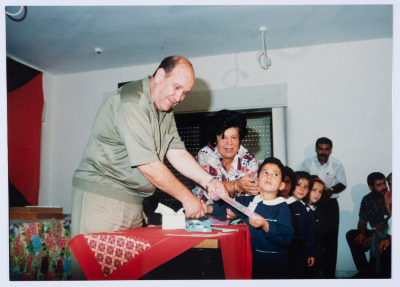 Handing certificates at the graduation ceremony of the kindergarten of Qalandiya Camp Women Handicraft Cooperative Society