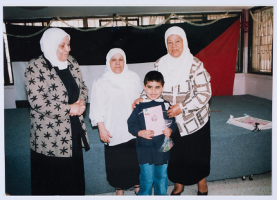 Handing certificates at the graduation ceremony of the kindergarten of Qalandiya Camp Women Handicraft Cooperative Society