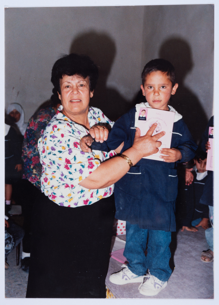 Handing certificates at the graduation ceremony of the kindergarten of Qalandiya Camp Women Handicraft Cooperative Society