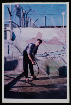 A prisoner cleaning the yard of a prison
