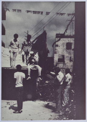 People riding a truck full of cargo 